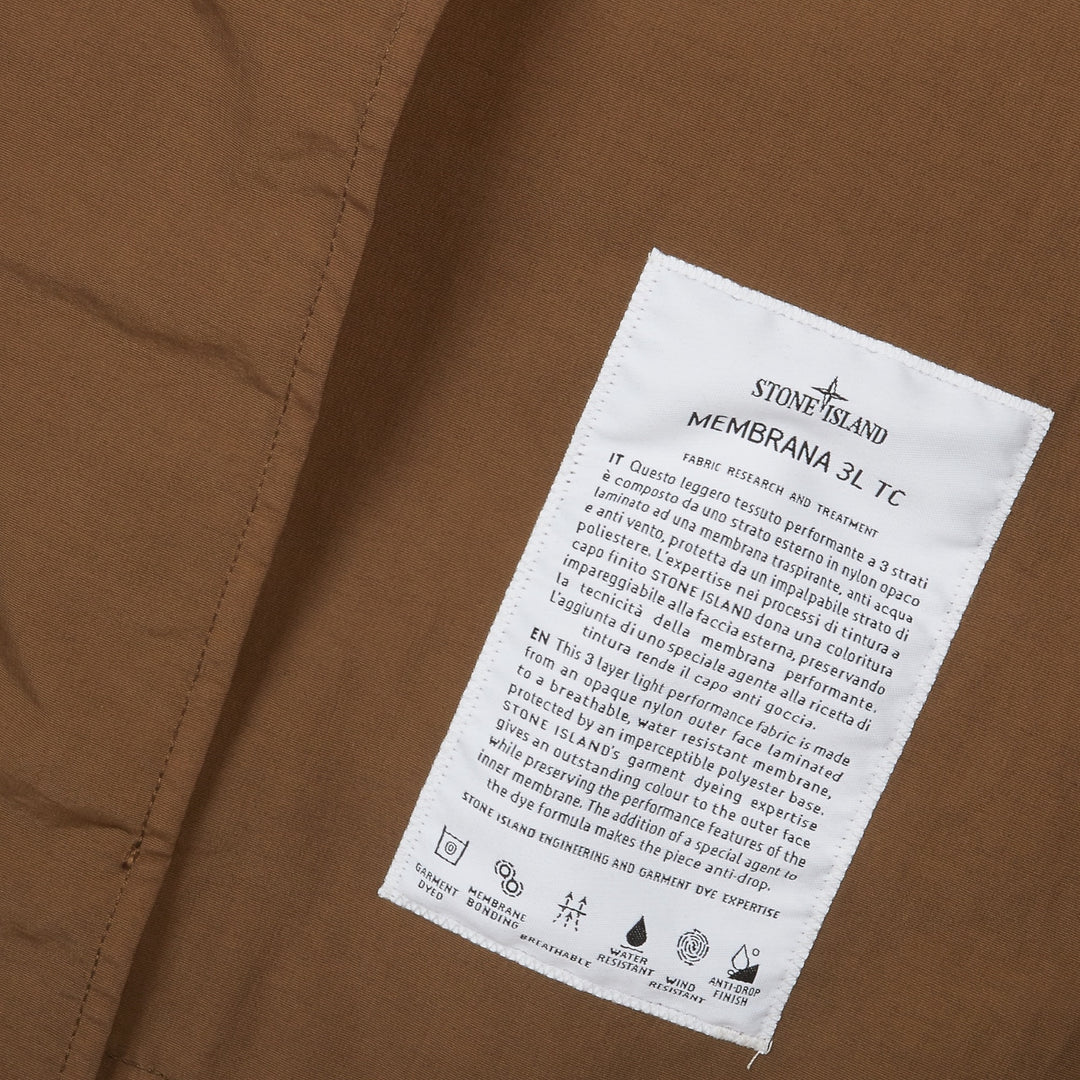 Ærmedetalje på Stone Island Membrana 3L TC Long Hooded Coat i Military Green med teknisk konstruktion.