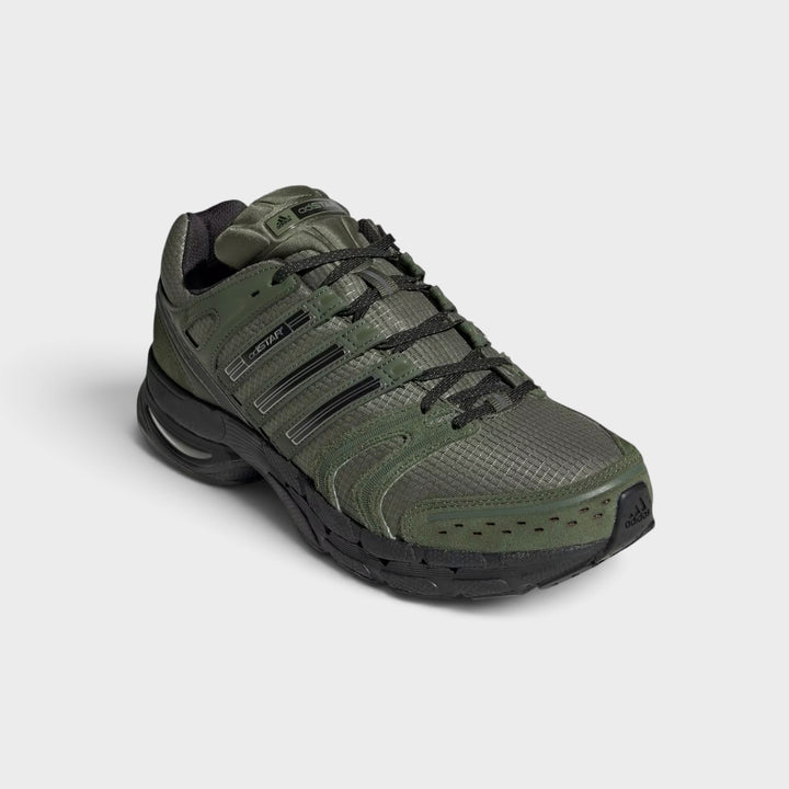 Adidas Adistar Control 5 i Base Green set skråt forfra med sorte snørebånd og lagdelte paneler.