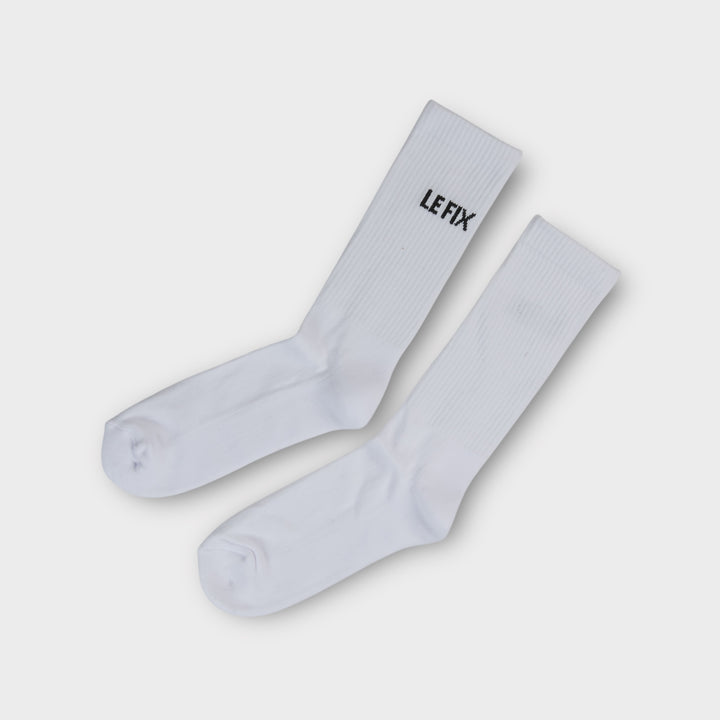 Hvide Le Fix Kaj tennis sokker med sort broderet logo på skaftet.