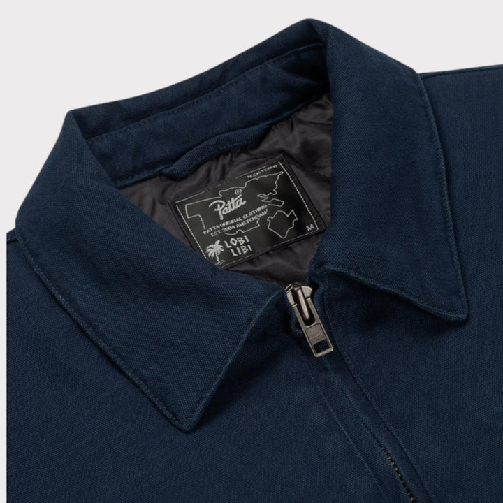Close-up af fløjlskrave brystlomme og workwear-detaljer på Patta Jacket