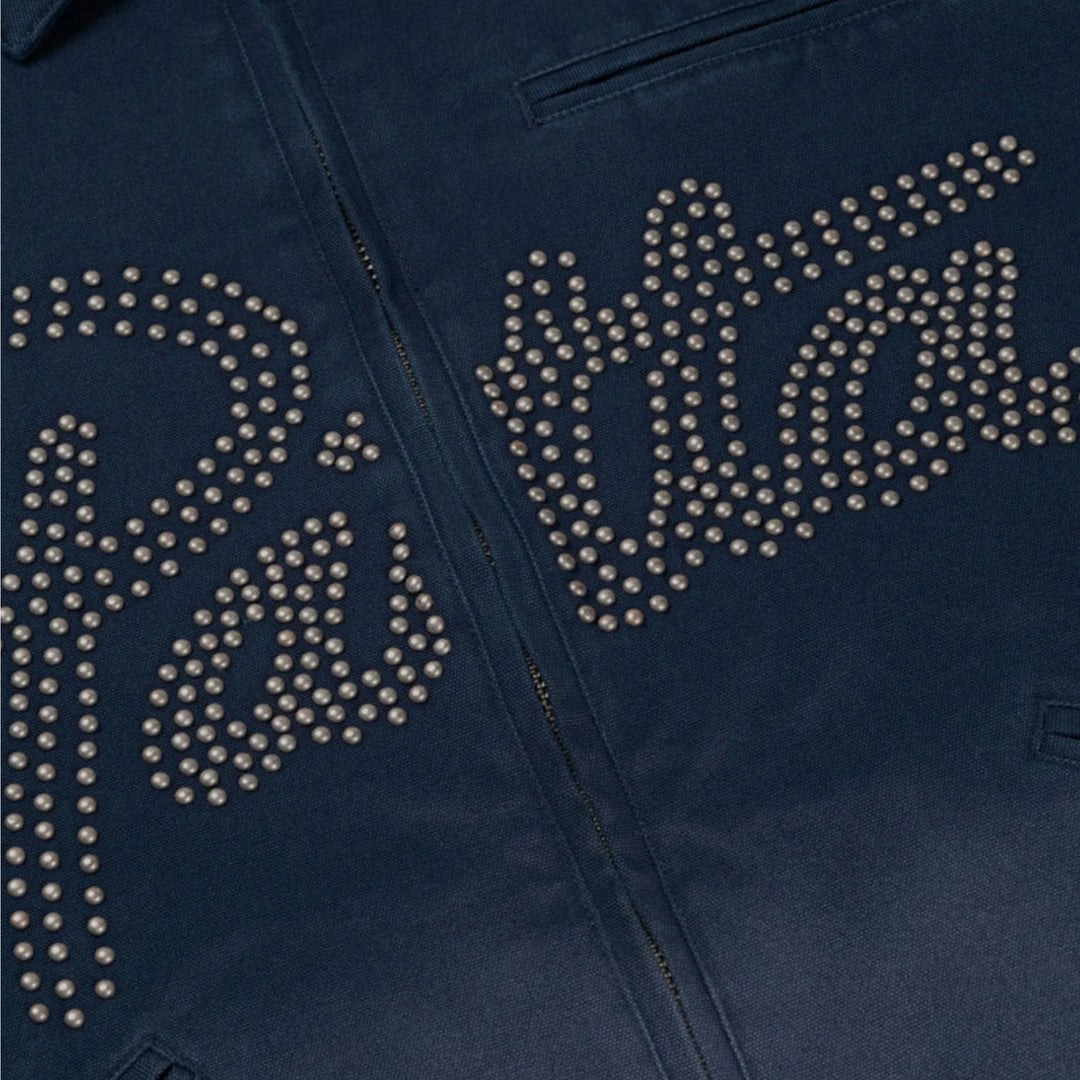 Close-up af sølvfarvede stjerne-studs og Patta-branding på Canvas Workwear Jacket