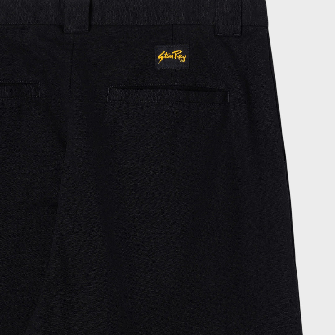 Nærbillede af indstukken baglomme og vævet Stan Ray-logomærke på A Pant i Black Canvas
